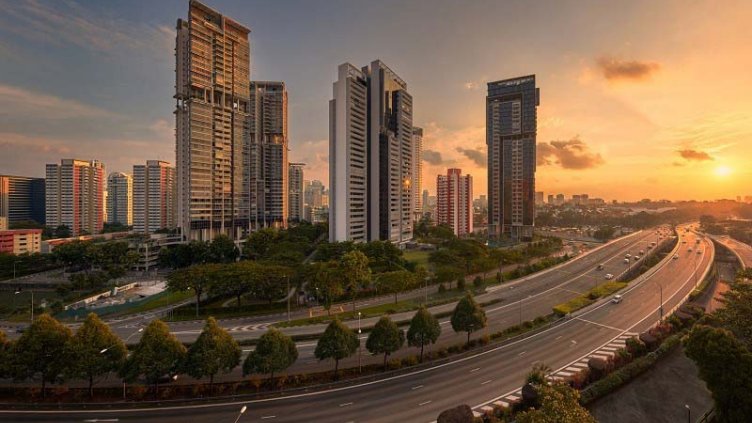 Beautiful sunset view of highway besides the skyscraper buildings