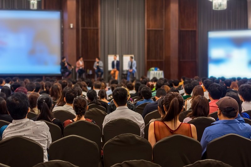 Abstract blurred photo of conference hall or seminar room with attendee background