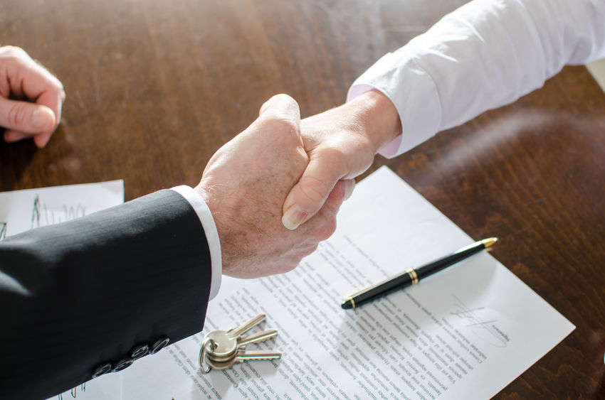 34423231 - estate agent shaking hands with his customer after contract signature