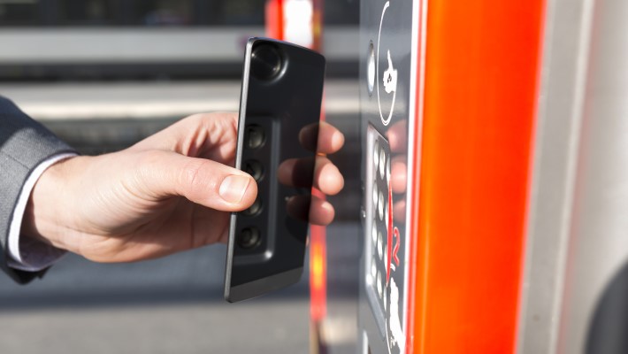 A Man doing transaction on digital POS using his phone