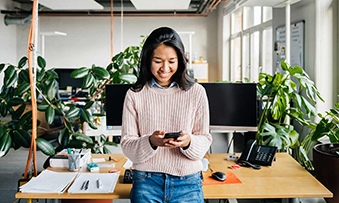 Happy employee in a green office, smiling.