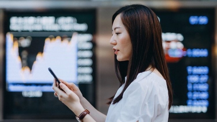 Women using her cell phone at her work station