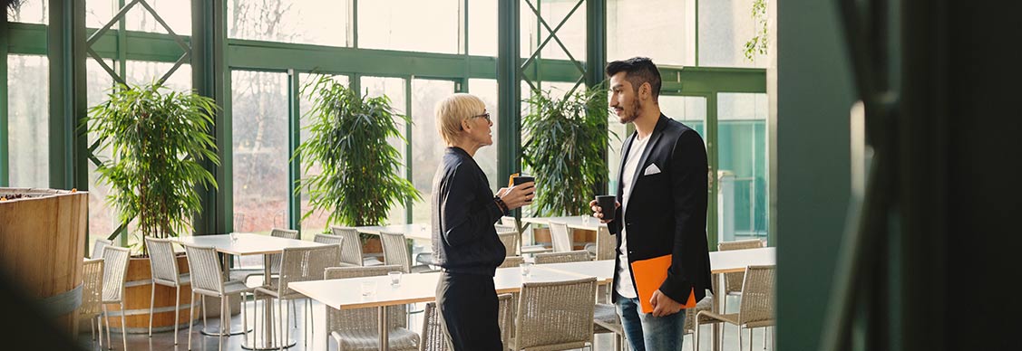 Employees at cafeteria with coffee cup