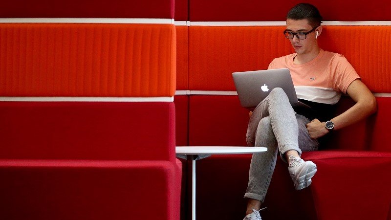 A man watching something on his MacBook