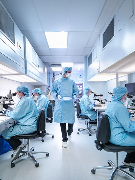 Clean room technicians and engineers test wafers and semiconductor materials