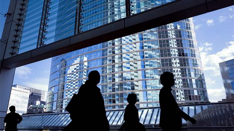 Employees walking through the lobby of an office building