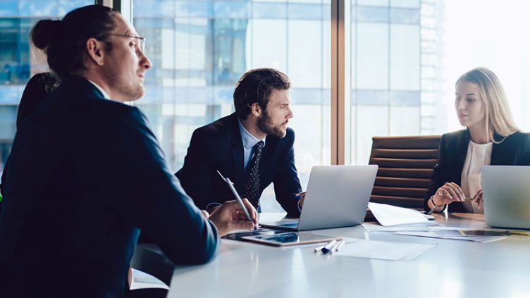 Employees discussing at meeting room