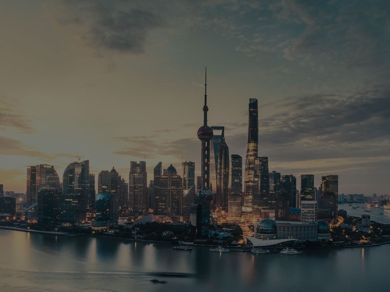 Night view of real estate high rise glass buildings in a smart city near a water body