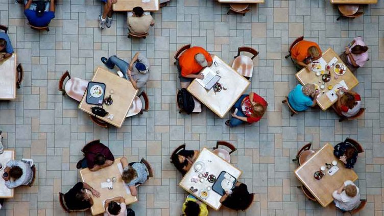 Diverse people sitting in a food hall