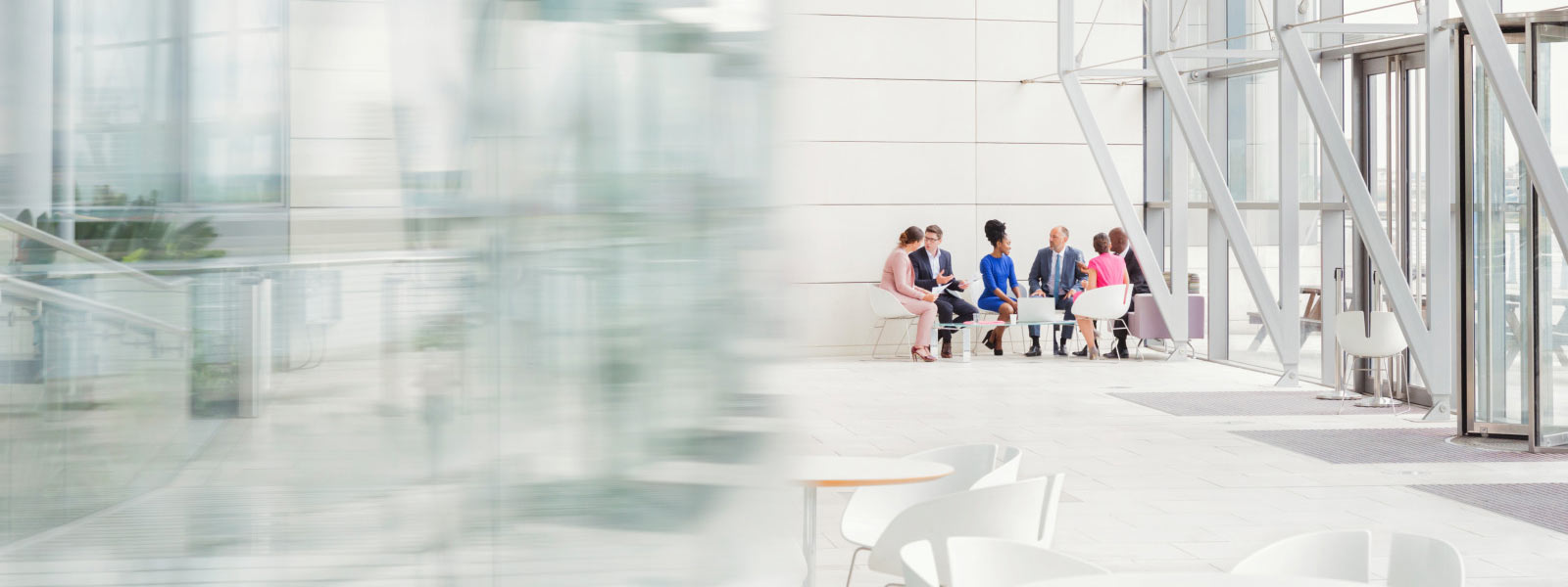 Business People Having Meeting In Modern Lobby