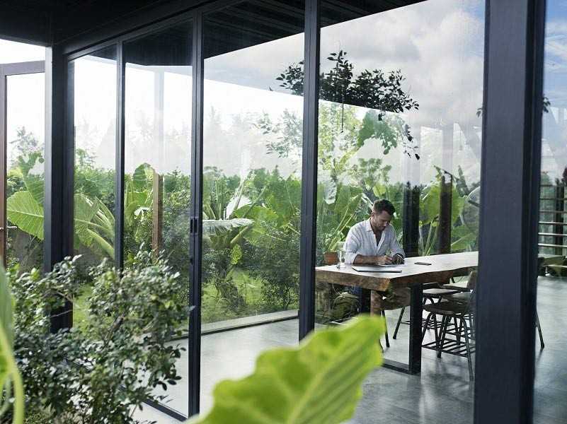 A man sitting and writing in an decarbonized room